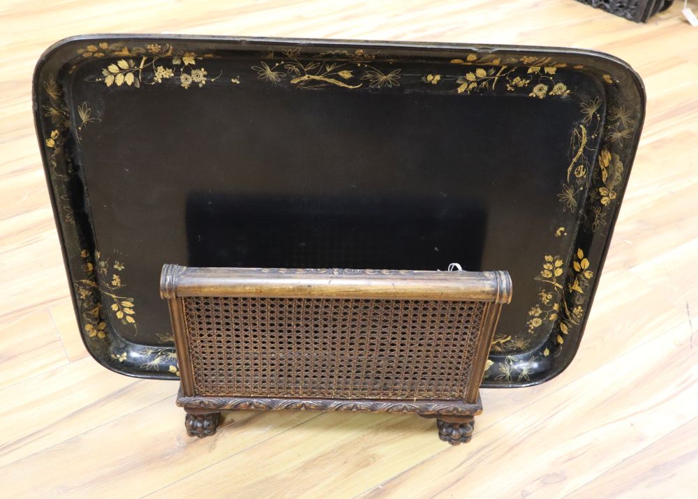 A large papier mache gilt-decorated tray and a 1930s carved oak Canterbury, with double rattan sides